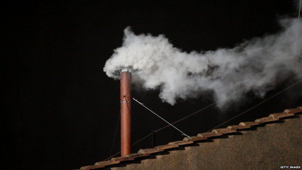 White smoke is seen from the roof of the Sistine Chapel