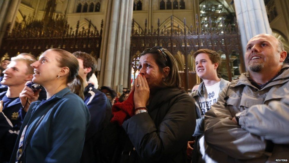 People react to the announcement of newly elected Pope Francis, Cardinal Jorge Mario Bergoglio of Argentina, at St Patrick's Cathedral in New York