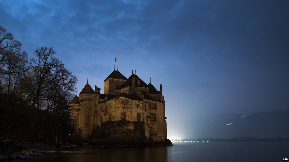 Chillon castle on the edge of Lake Geneva, seen during Earth Hour