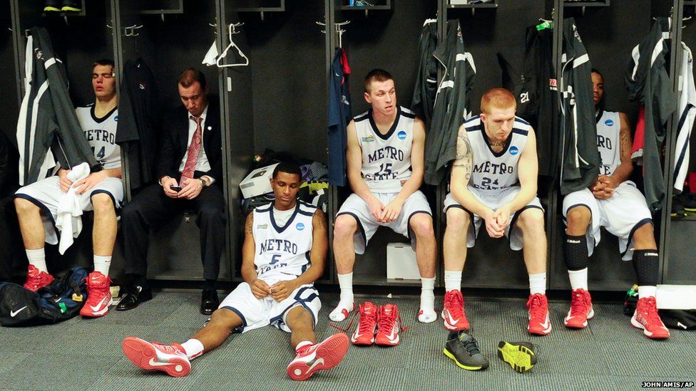 Metro State players sit in the locker room