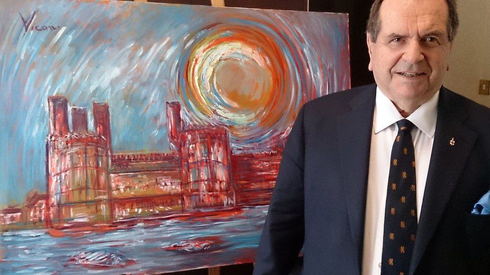 Andrew Vicari in front of his painting of Caernarfon Castle