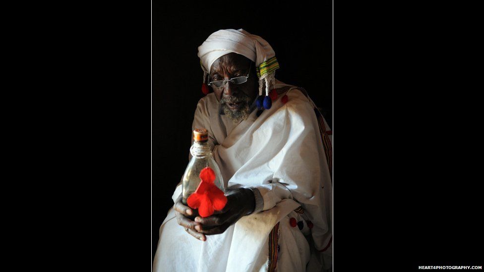 A traditional healer in southern Tanzania holding a bottle