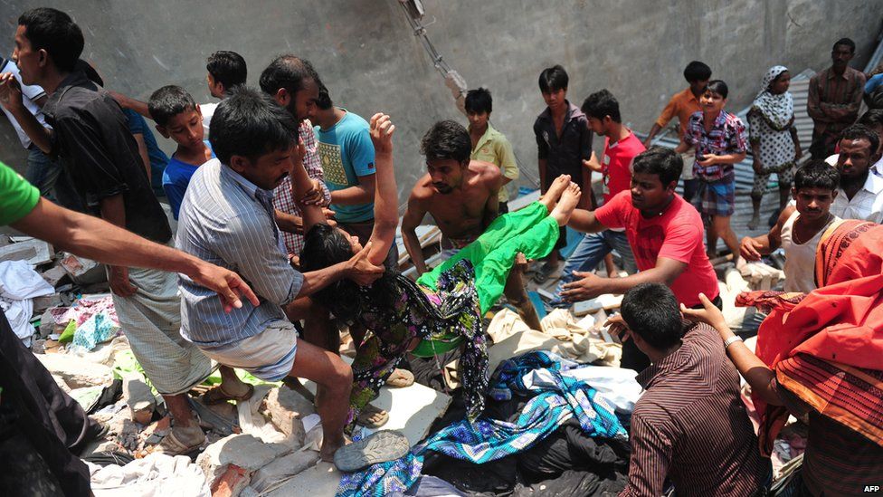 Bangladeshi garment workers help evacuate a survivor after an eight-storey building collapsed in Savar, on the outskirts of Dhaka, on April 24, 2013.