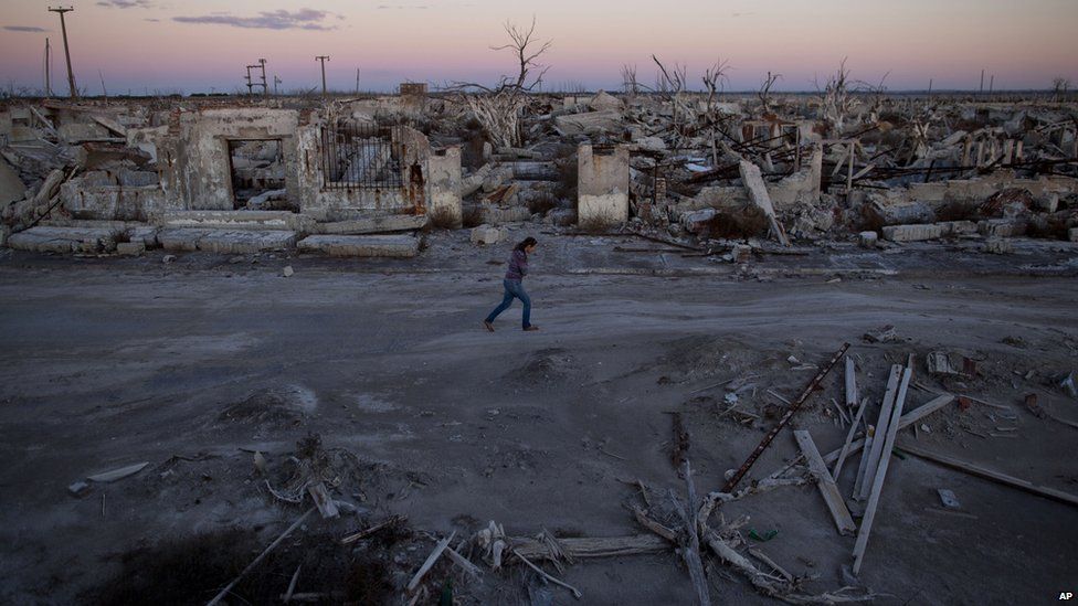 A woman walks through what was a street in Epecuen, Argentina, on 6 May 2013