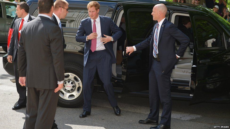 Prince Harry with security