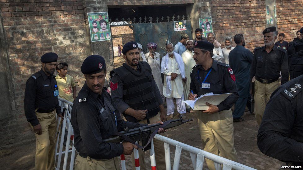 Police outside a polling station in Lahore