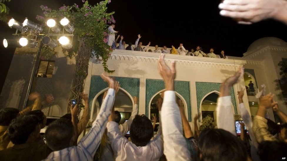 PML-N leader Nawaz Sharif (fourth from left) waves to his supporters at a party office in Lahore on Saturday evening