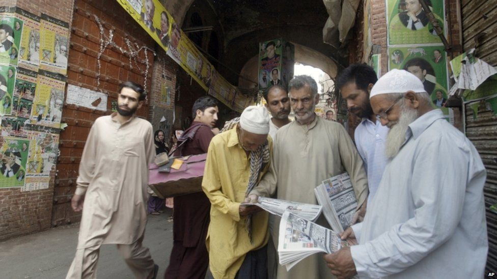 People in Lahore read about the election on Sunday morning