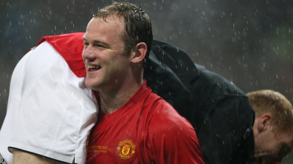 Manchester United's Wayne Rooney celebrates winning the Champions League trophy by carrying team mate Paul Scholes over his shoulder