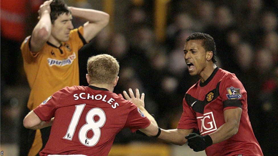 Manchester United's Paul Scholes (left) celebrates with his team mate Luis Nani after scoring the first goal of the game making it his 100th Premier League goal