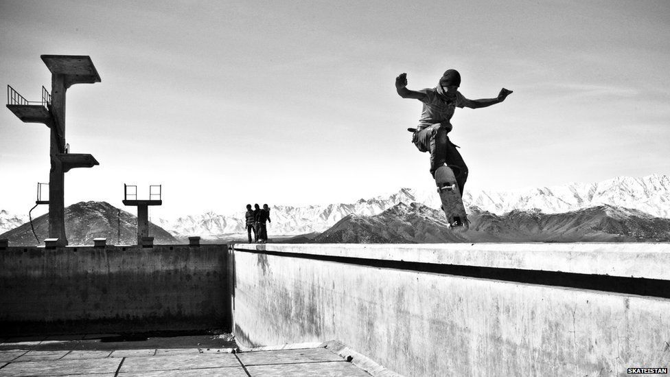 Boy skating against a mountain backdrop
