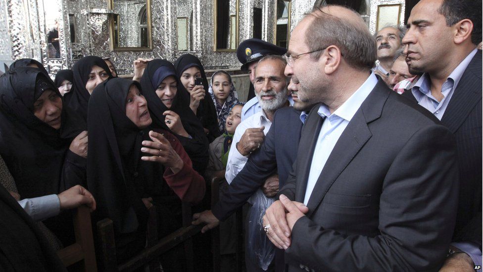 Tehran Mayor and Iranian presidential candidate, Mohammad Bagher Qalibaf, listens to women as he arrives at a polling station for the presidential election in Tehran, June 14. He also has a high-profile wife with her own political identity.