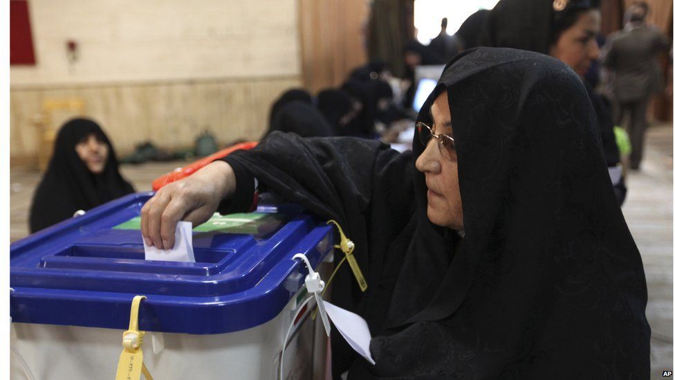 An Iranian woman casts her ballot in the presidential election at a polling station in Tehran, June 14.