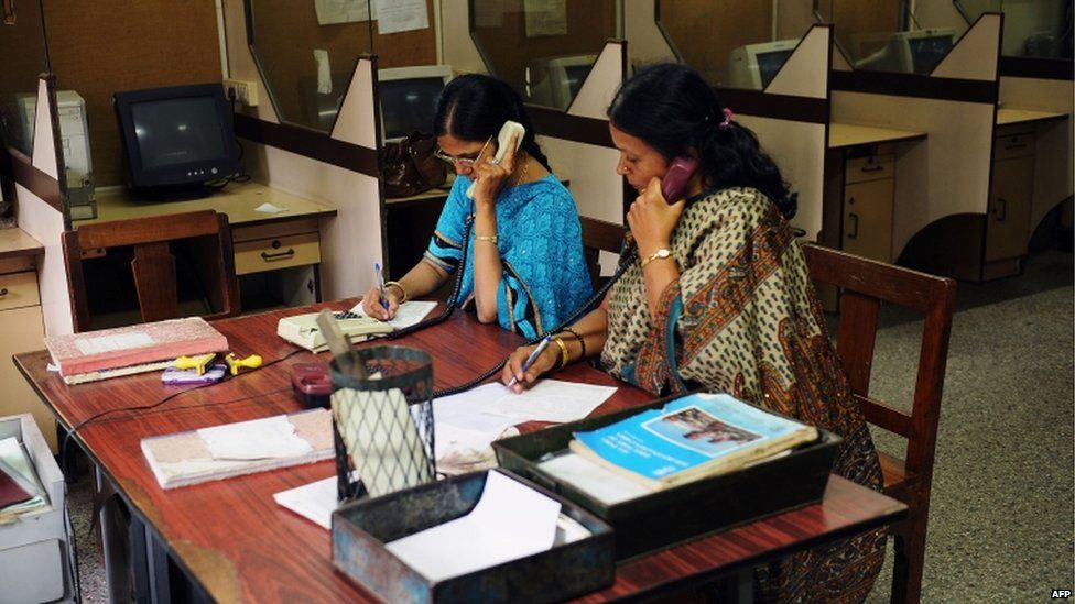 Employees at the phonogram section transcribe voice messages from customers, which will then be sent to the the receiving party as a telegram, at a telecommunications office in Bangalore