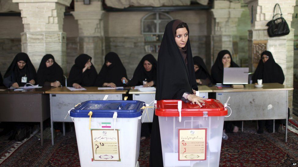 Iranian woman casts vote at polling station in Qom. 14 June 2013
