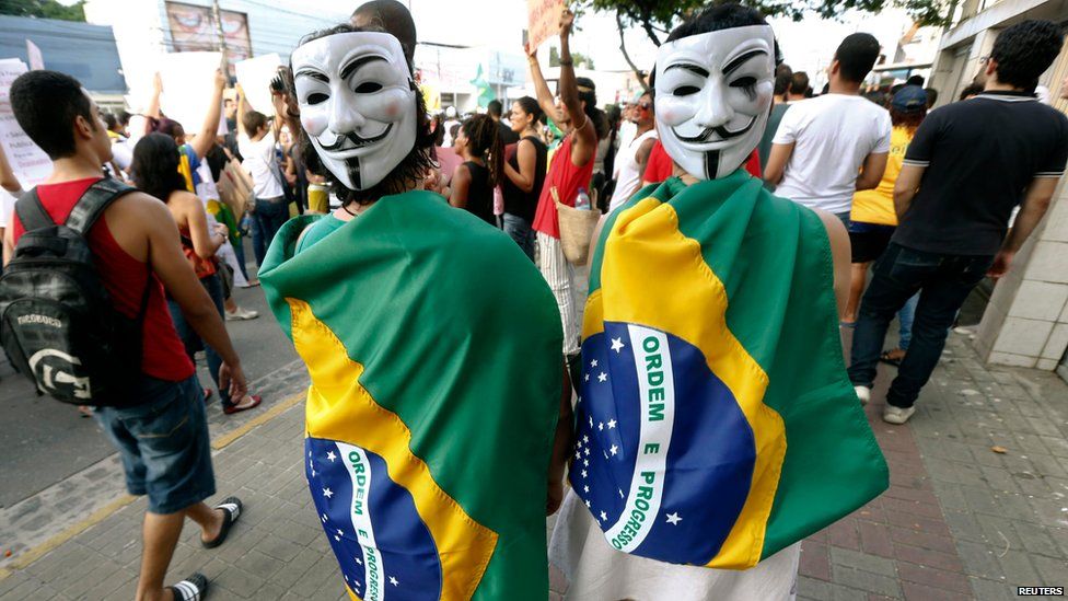 Demonstrators wearing Guy Fawkes masks in Recife city on 20 June 2013