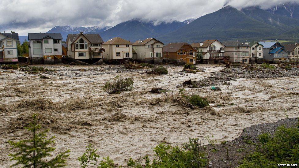 Houses damaged along the edge of Cougar Creek are shown June 20, 2013 in Canmore, Alberta, Canada. Widespread flooding caused by torrential rains washed out bridges and roads prompting the evacuation of thousands.