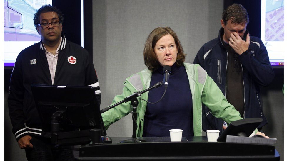 Alberta Premier Alison Redford, centre, addresses the media as Calgary Mayor Naheed Nenshi, left, and Alberta Municipal Affairs Minister Doug Griffiths look on during a news conference in Calgary, Alberta, Canada Friday, June 21, 2013.