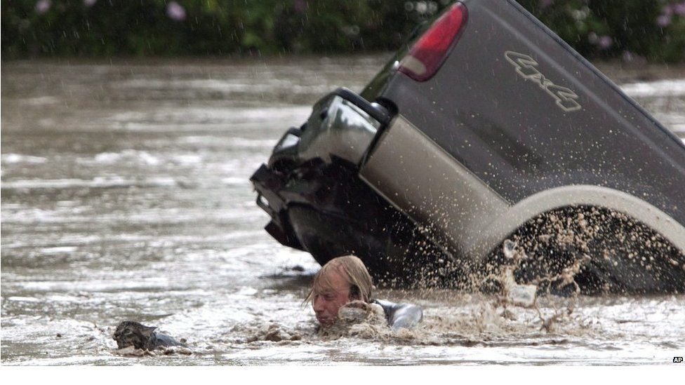 Kevan Yaets swims after his cat Momo to safety in High River, Alberta, Canada on Thursday June 20, 2013. Both man and cat are reported to be safe and sound after their ordeal.