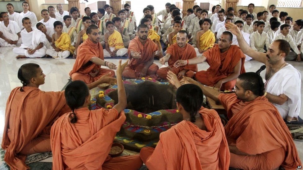 Students of Swaminarayan Gurukul Vishwavidhya Pratishthanam (SGVP) perform rituals during a “yagya,” or a fire ritual, to pray for the Uttarakhand flood victims in