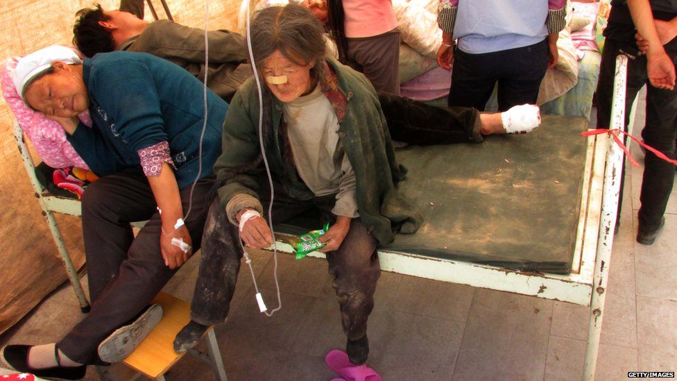 Injured people get treatment in a hospital after an earthquake hit Minxian county in China's north-west Gansu province on 22 July, 2013.