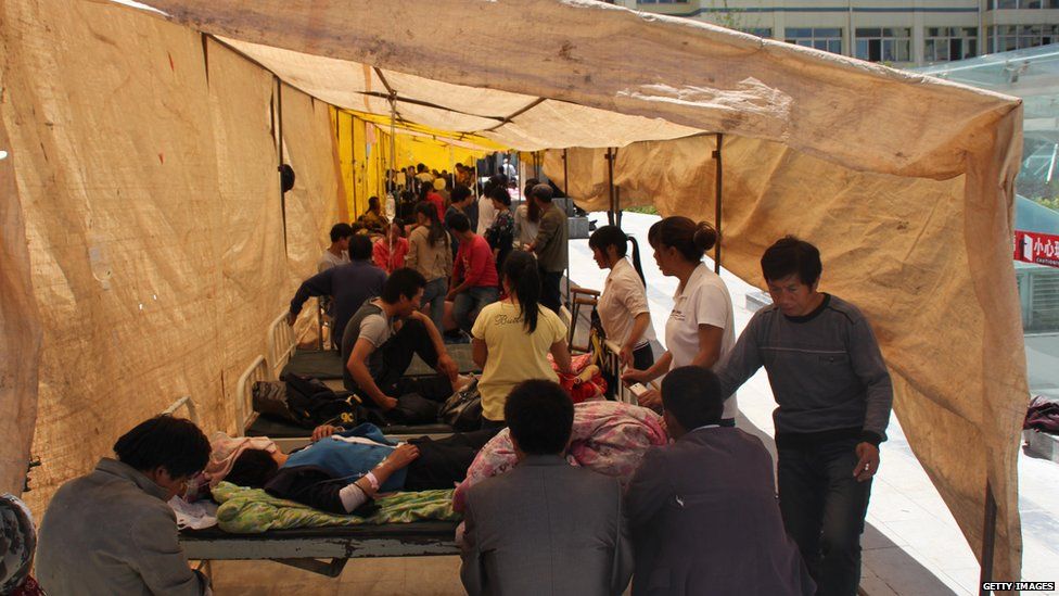 Injured residents get treatment in a makeshift hospital after an earthquake hit Minxian county in north-west China's Gansu province on 22 July 2013.