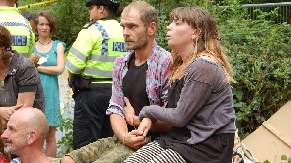 Man and woman waiting to be arrested