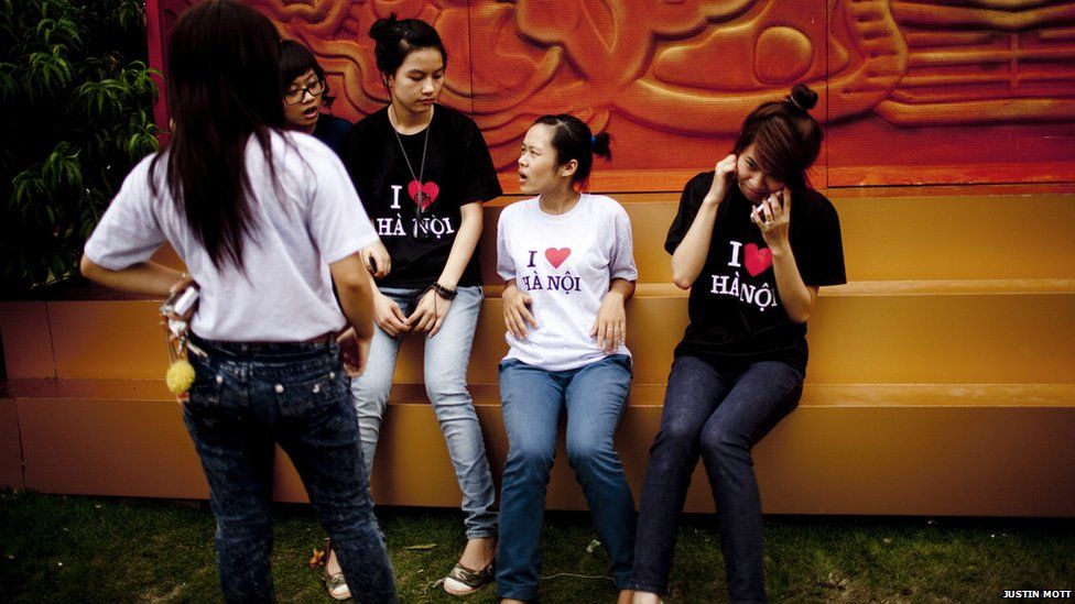 A group of students wearing "I love Hanoi T-Shirts in front of the Ho Chi Minh Mausoleum in Hanoi.
