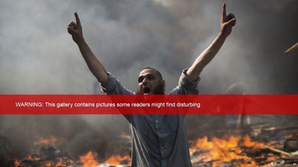 A supporter of ousted Islamist President Mohammed Morsi shouts during clashes with Egyptian security forces in Cairo's Nasr City district, Egypt, Wednesday, Aug 14, 2013