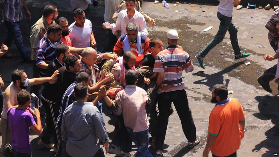 Wounded protester carried to ambulance. 14 Aug 2013