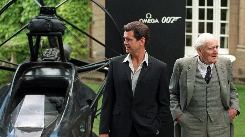 Actor Pierce Brosnan (L) poses for a photograph with Desmond Llewelyn
