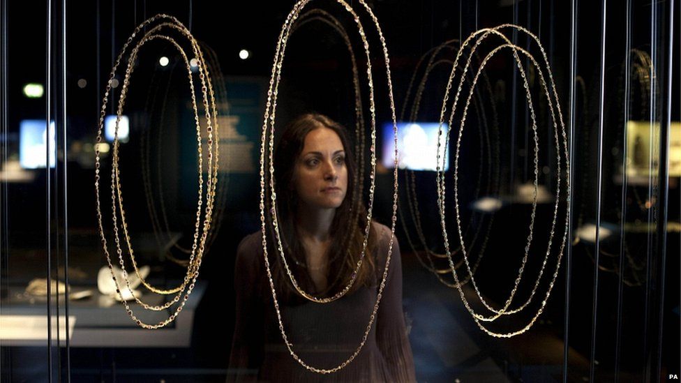 Elpie Psalti, Museum of London exhibition project manager, looks at a selection of bejewelled necklaces and chains included in the Cheapside Hoard