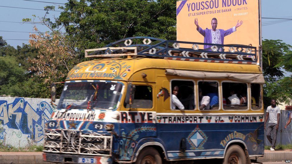 A bus passing a Youssou Ndour concert poster, Dakar, Senegal - Wednesday 9 October 2013