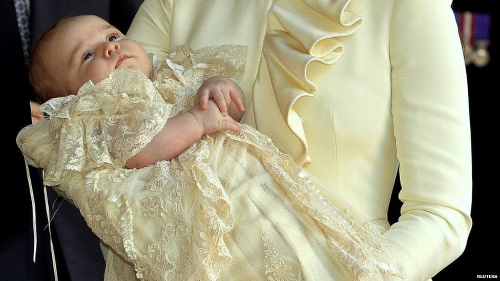 Prince George held by his mother