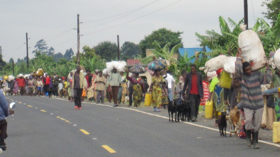 A picture taken by Ignatius Bahizi in which thousands of displaced people walk along the road from Bunagana to Kisoro town in Uganda on 4 November