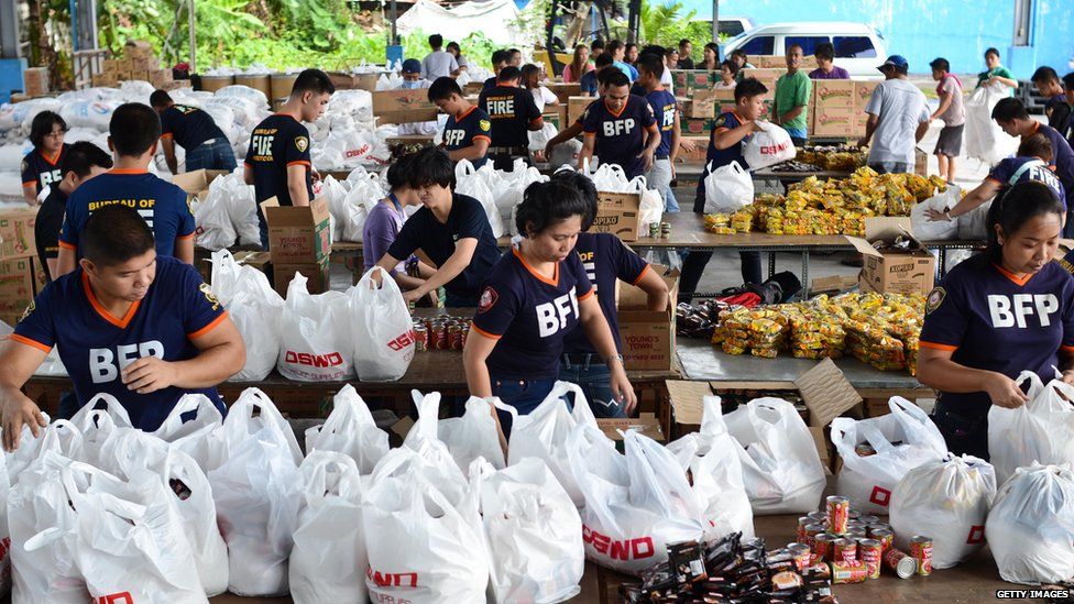 Bureau of Fire Protection volunteers pack relief goods at government warehouse on in Manila, Philippines. 9 Nov 2013