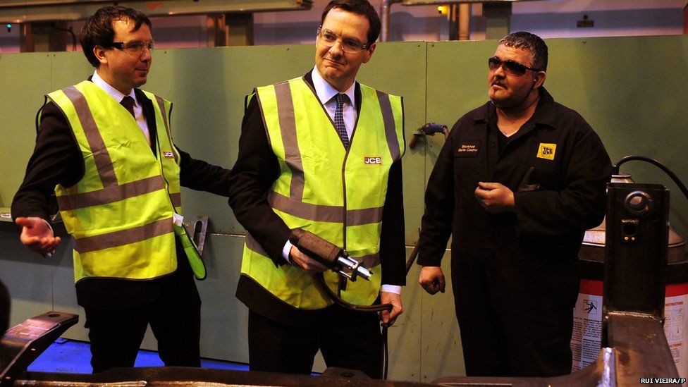 Britain's Chancellor of the Exchequer George Osborne uses a stud gun during a visit to JCB's backhoe loader factory in Rocester, Staffordshire