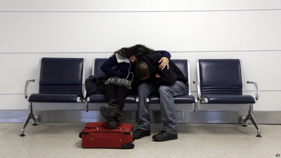 A couple are stranded at Lambert-St. Louis International Airport after a snowstorm led to the cancellation of their flight home to Miami