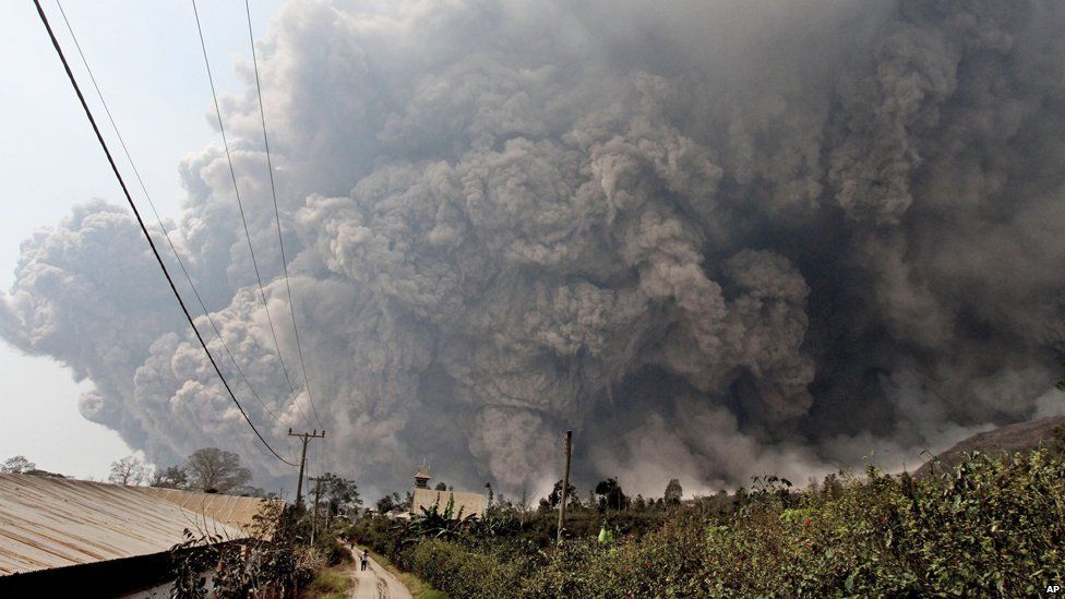 Mount Sinabung releases pyroclastic flows during an eruption as seen from Namantaran, North Sumatra, Indonesia, Saturday, Feb. 1,