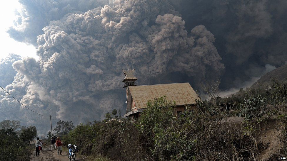 A giant cloud of hot volcanic ash clouds engulfs villages in Karo district during the eruption of Mount Sinabung volcano located in Indonesia's Sumatra island on February 1