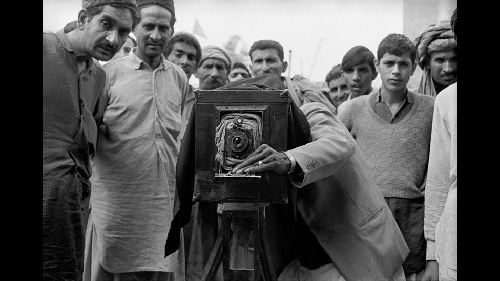 A Pakistani photographer operating a paper-negative box camera near Peshawar, Pakistan.