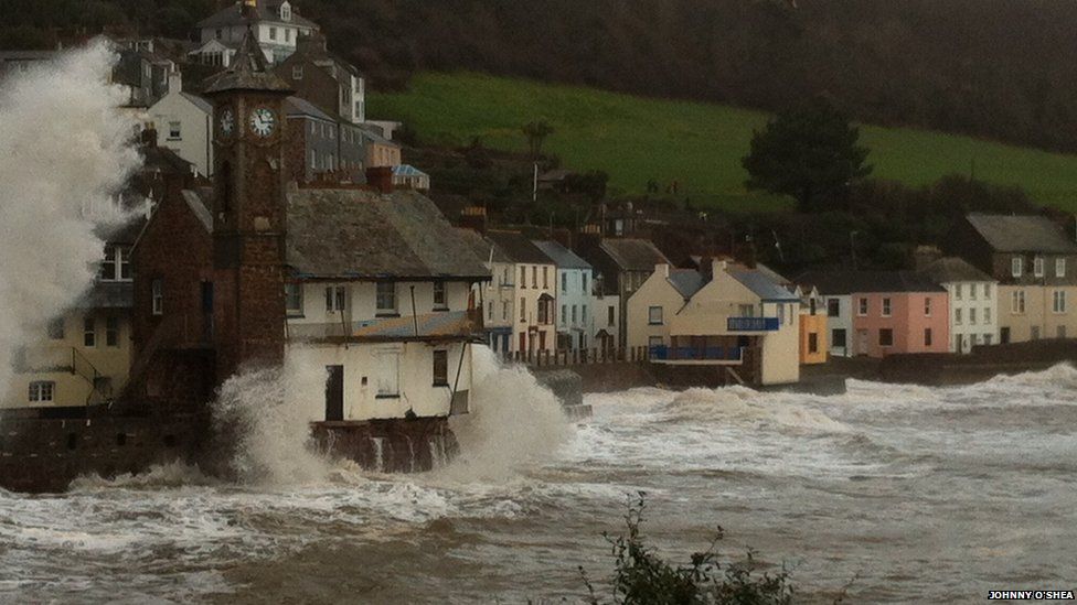 The clock tower in Kingsand is battered by waves caused by the stormy weather