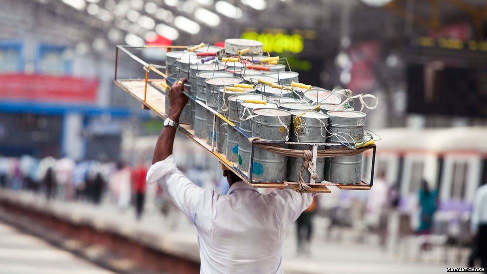 Dabbawala with crate of tiffin tins on his head