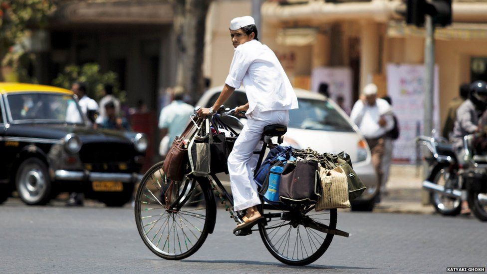 Dabbawala on a heavily laden bicycle