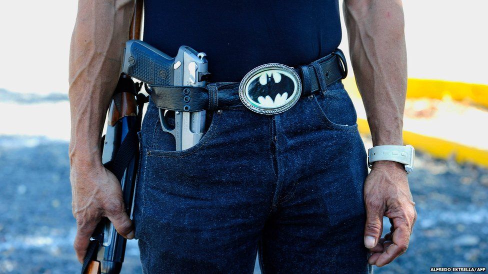 A man poses with a Batman belt in Michoacan