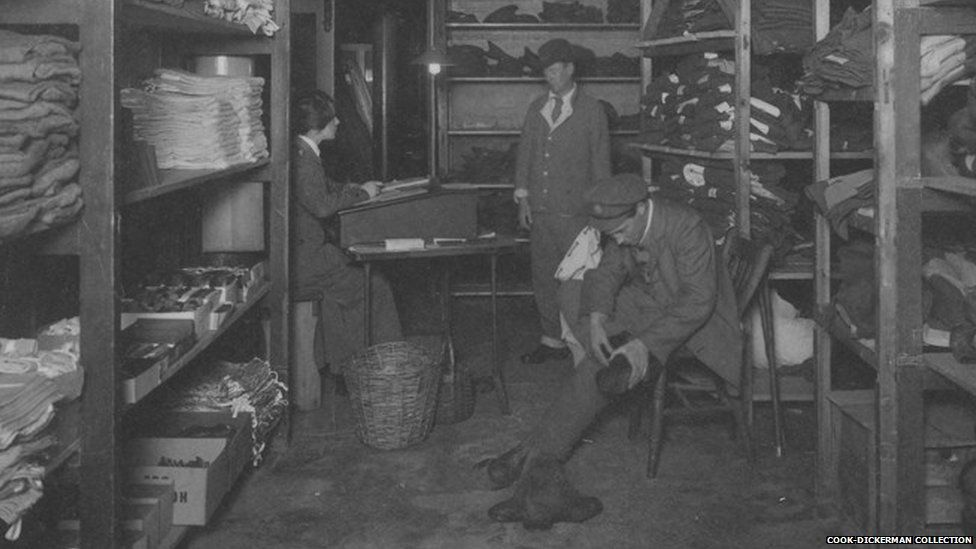 A female orderly kitting out two patients in the clothing store at Endell Street Military Hospital during World War One