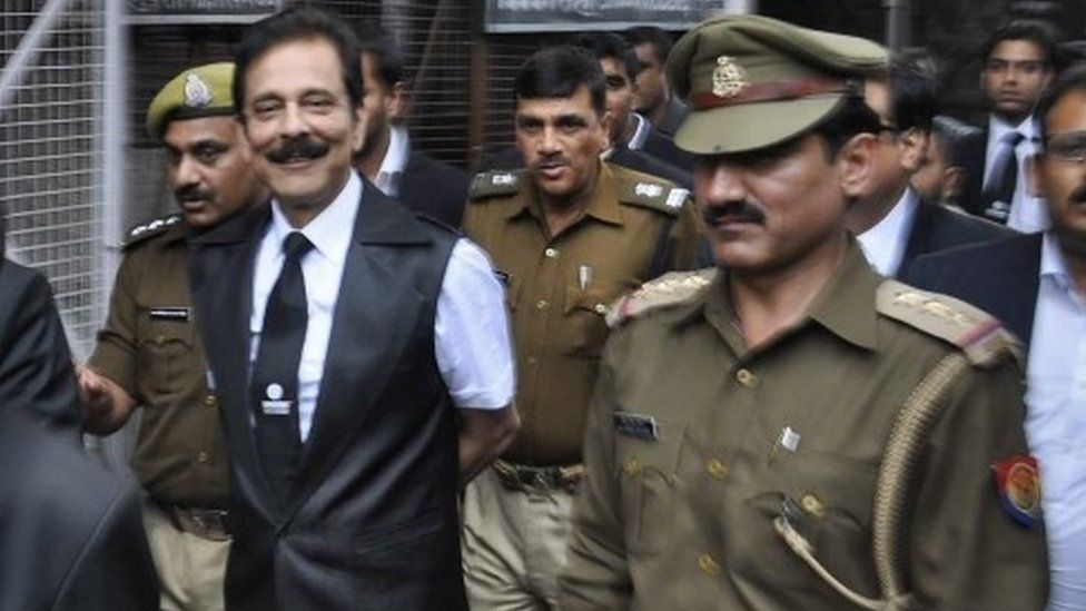 The Sahara group chairman Subrata Roy being escorted to a court in the city of Lucknow on February 28, 2014.