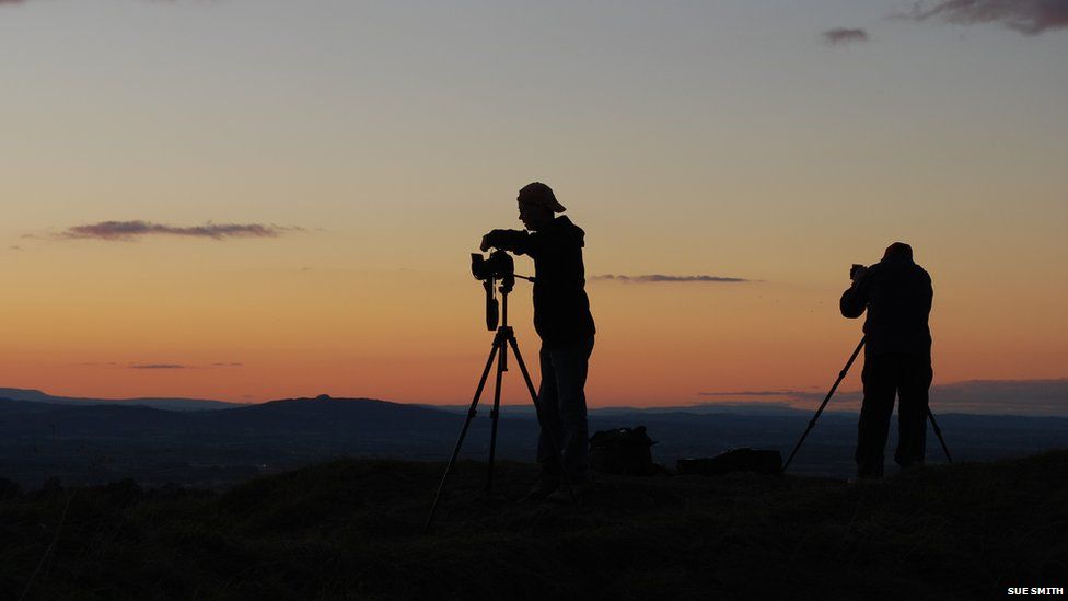 Photographers and a sunset