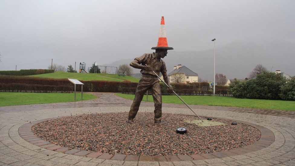 Statue wearing a traffic cone