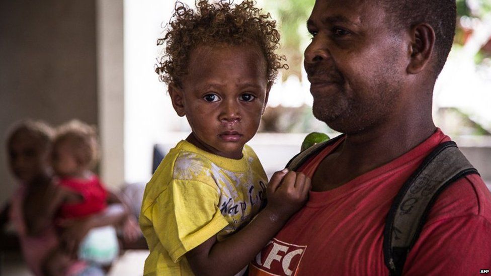 A handout photo taken on 5 April, 2014 shows people sheltering at the evacuation centre at "Panatina Pavilion" in the Solomon Islands capital of Honiara